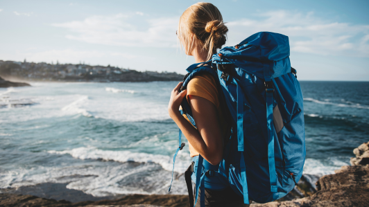Woman with backpack looking into the distance